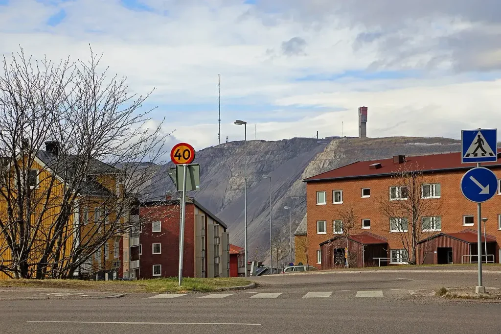 The terraced Kiirunavaara iron ore mountain and LKAB mine buildings above the town of Kiruna, Sweden
