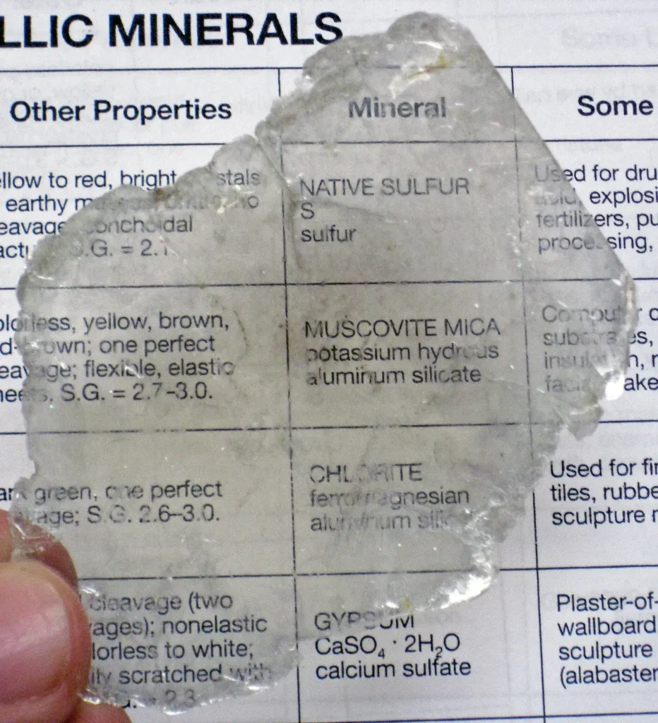 Muscovite mica specimen photographed against a plain background