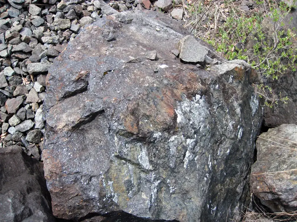 Coarse grey-black magnetite-ilmenite ore at the old Tahawus mine near Sanford Lake, Adirondack Mountains