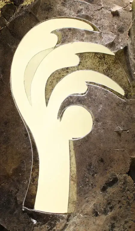 Thin transparent sheet of mica cut into the shape of a bird's claw by Hopewell craftspeople