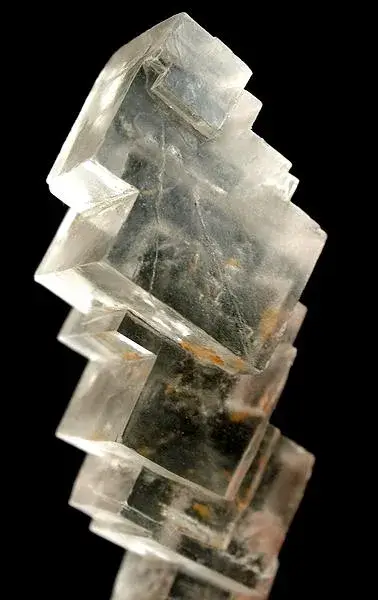 Cluster of colourless transparent cubic halite crystals on a pale matrix