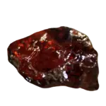 Rough translucent red garnet gemstone on black background