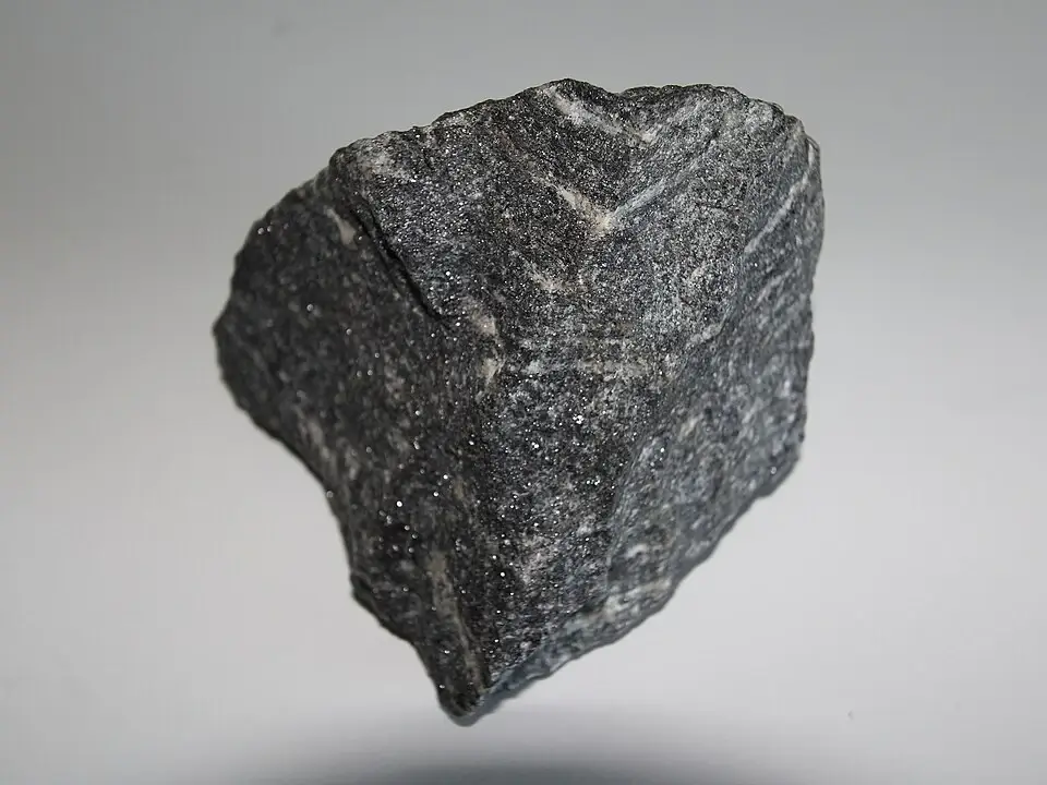 Polished fragment of Acasta gneiss showing fine grey-and-pink banding, the oldest precisely dated rock on Earth