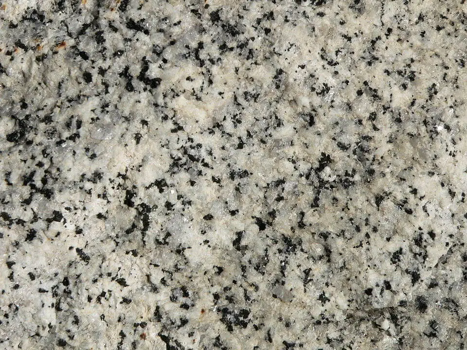 Coarse-grained granite outcrop showing quartz, feldspar, and biotite at hand-specimen scale