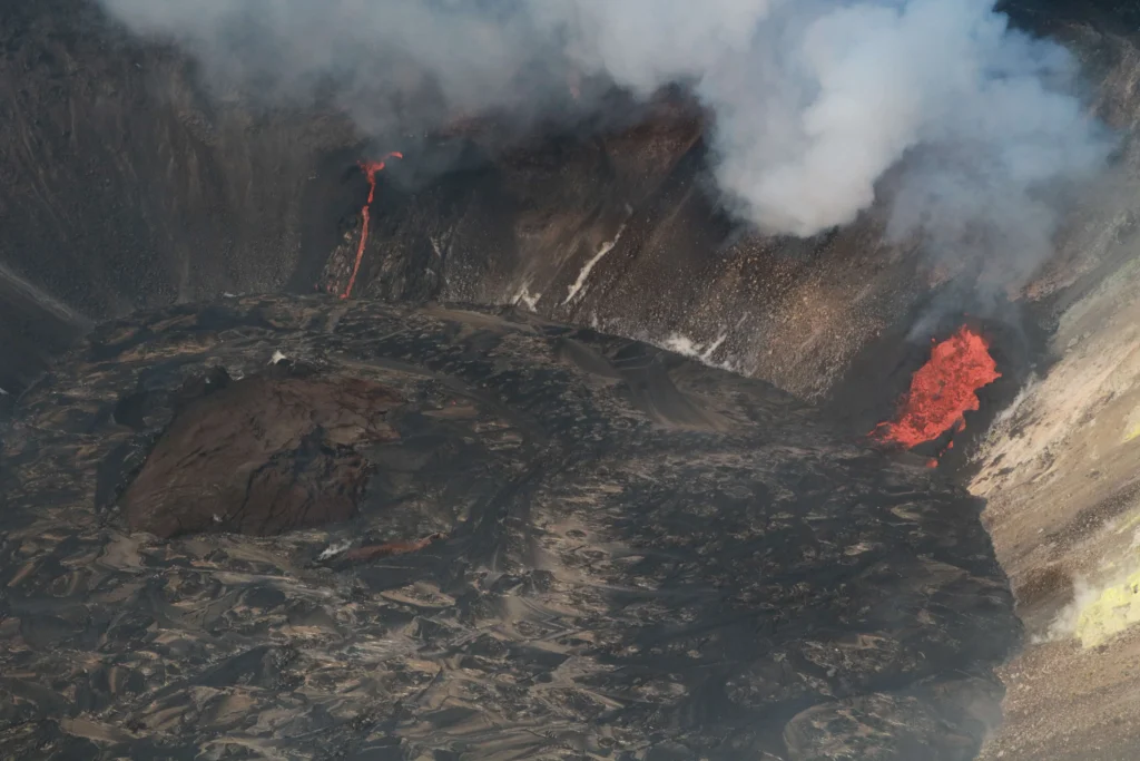 Aerial view of glowing lava and two active fissures inside Halemaumau crater at the summit of Kilauea volcano, Hawaii, December 2020