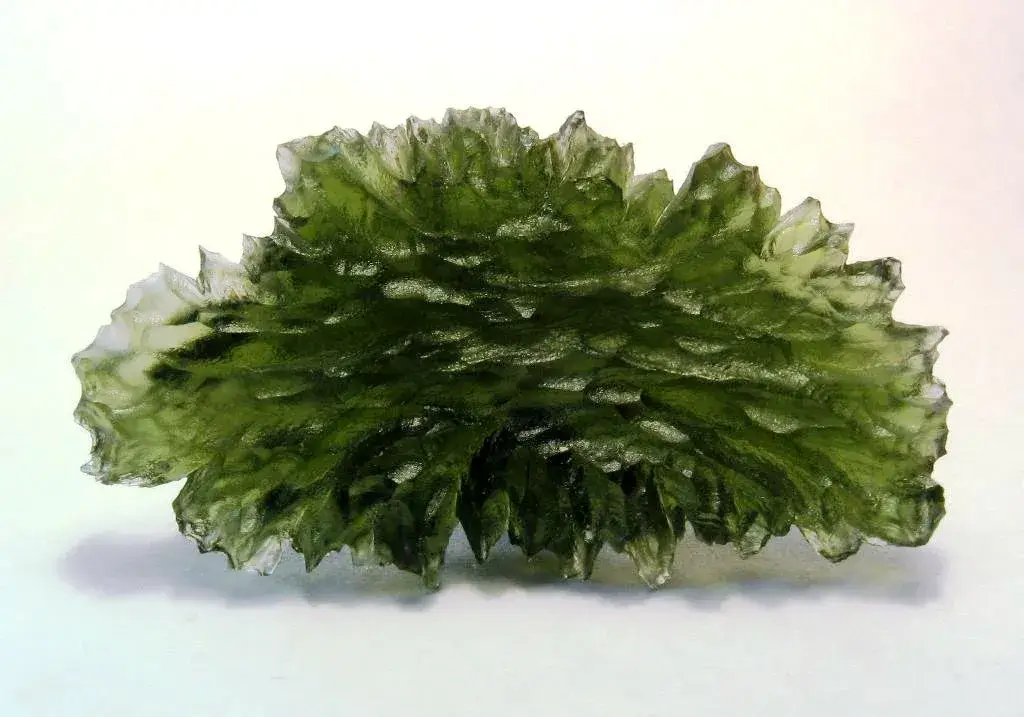 Deeply etched green moldavite tektite specimen from Besednice in the Czech Republic, formed by the Ries meteorite impact in Germany 15 million years ago