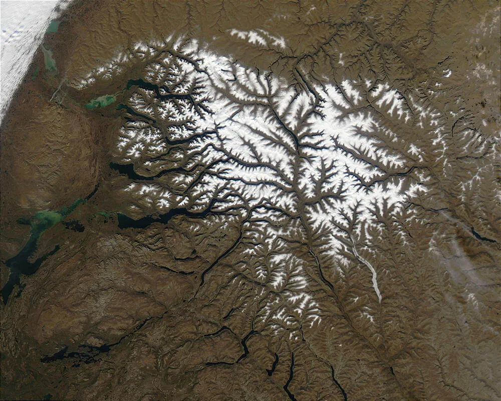 Snow-covered ridges of the Putorana Plateau in northern Siberia, layered basalt flows of the Siberian Traps that drove the end-Permian extinction.