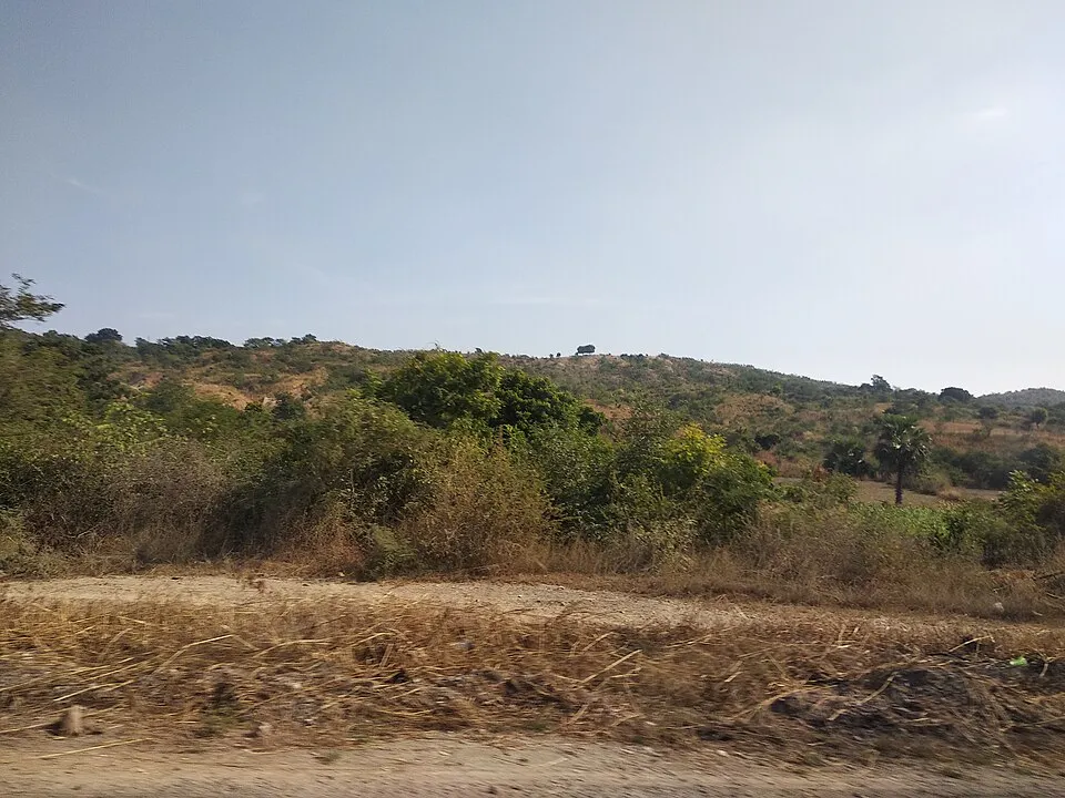 A view of the Sagaing Fault trace running through dry agricultural land outside Mandalay, Myanmar, photographed before the 2025 rupture, with the linear topographic expression of the fault visible in the middle distance.