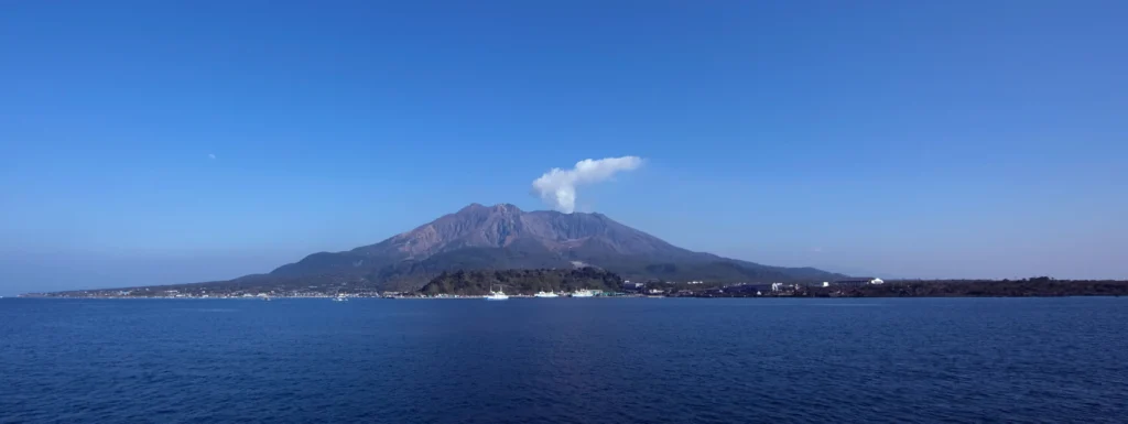 Sakurajima volcano erupting an ash plume across the bay from Kagoshima, Japan