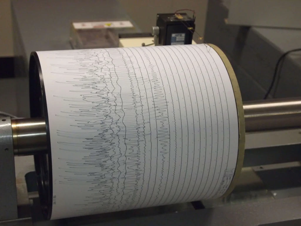 A seismogram showing wavy traces of ground motion from a recorded earthquake