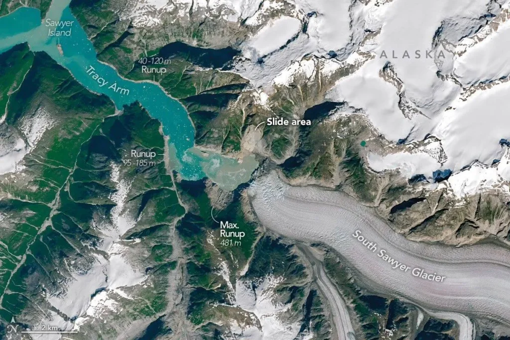 Landsat 9 satellite view of Tracy Arm fjord in Alaska on 19 August 2025, showing a bright landslide scar on the north wall and a brown bathtub ring of stripped vegetation marking the tsunami runup zone