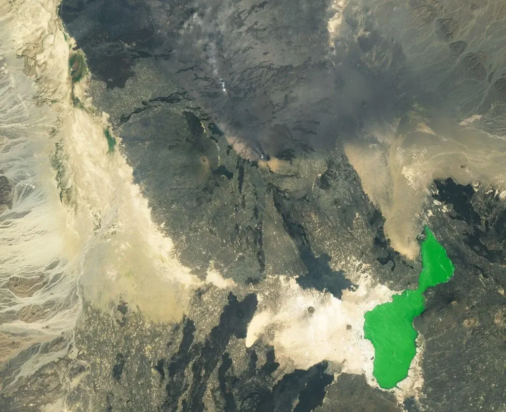 Landsat 9 satellite image of the Erta Ale–Hayli Gubbi volcanic landscape on 24 November 2025, with the enlarged summit crater of Hayli Gubbi and two new craters visible to the south-east, ash blanketing older lava flows, and Erta Ale's craters in the upper part of the frame