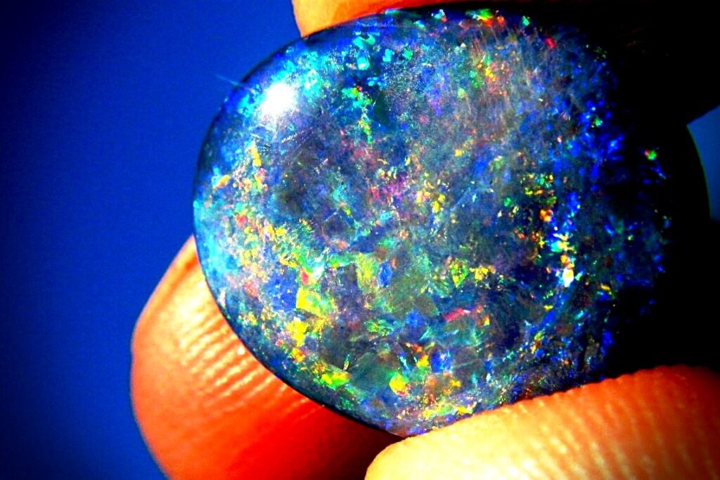 An eight-carat Lightning Ridge black opal flashing green and blue against a dark body tone