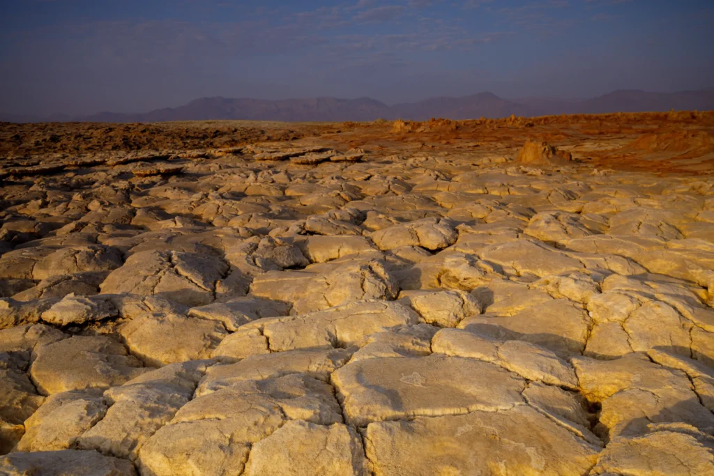 Cracked, sun-baked dry landscape in the Danakil Depression, one of the hottest places on Earth