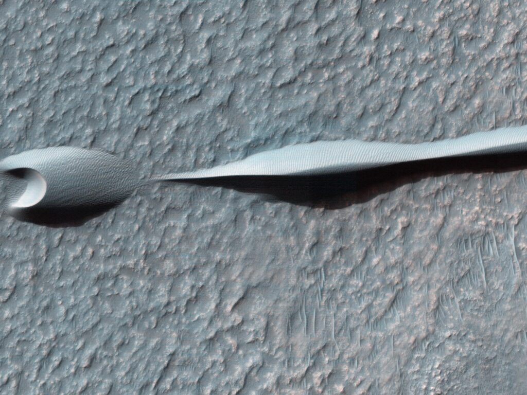 Crescent-shaped barchan sand dunes on the surface of Mars, imaged from orbit by NASA's Mars Reconnaissance Orbiter