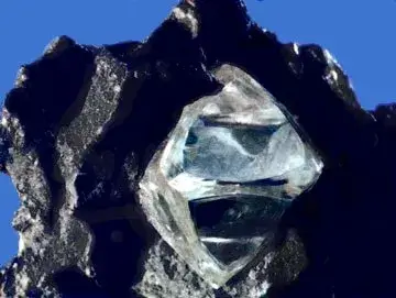 Rough octahedral diamond crystal in host rock matrix