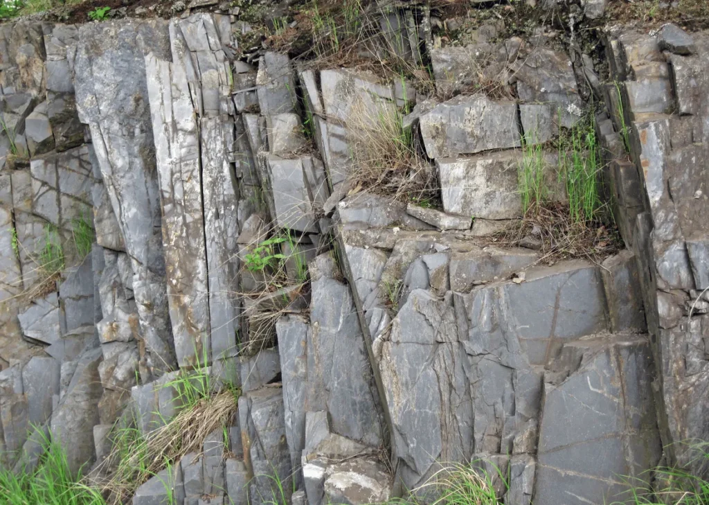 Hand specimen of grey slate showing flat parallel cleavage