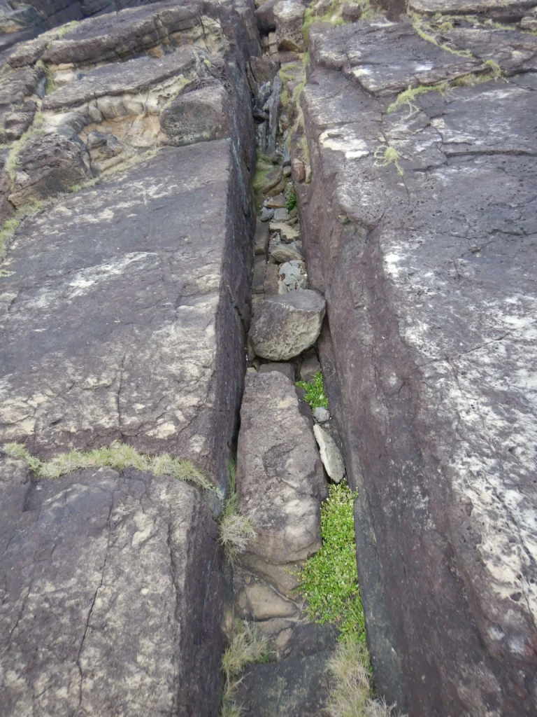 Straight natural channel crossing stepped sandstone terraces at Sanninu-dai, Yonaguni, above water