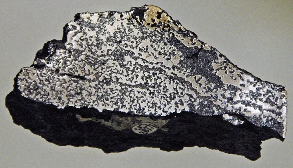 Cut slab of basalt from the Siberian Traps containing native iron