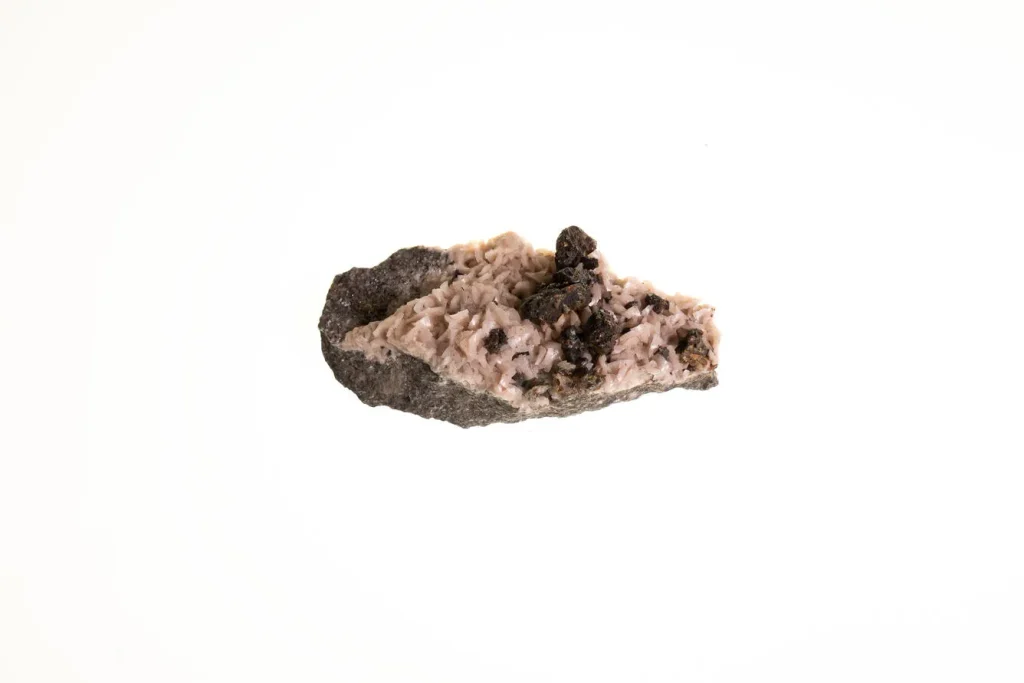 Close-up of a white crystalline dolomite specimen with dark resinous sphalerite crystals scattered across it