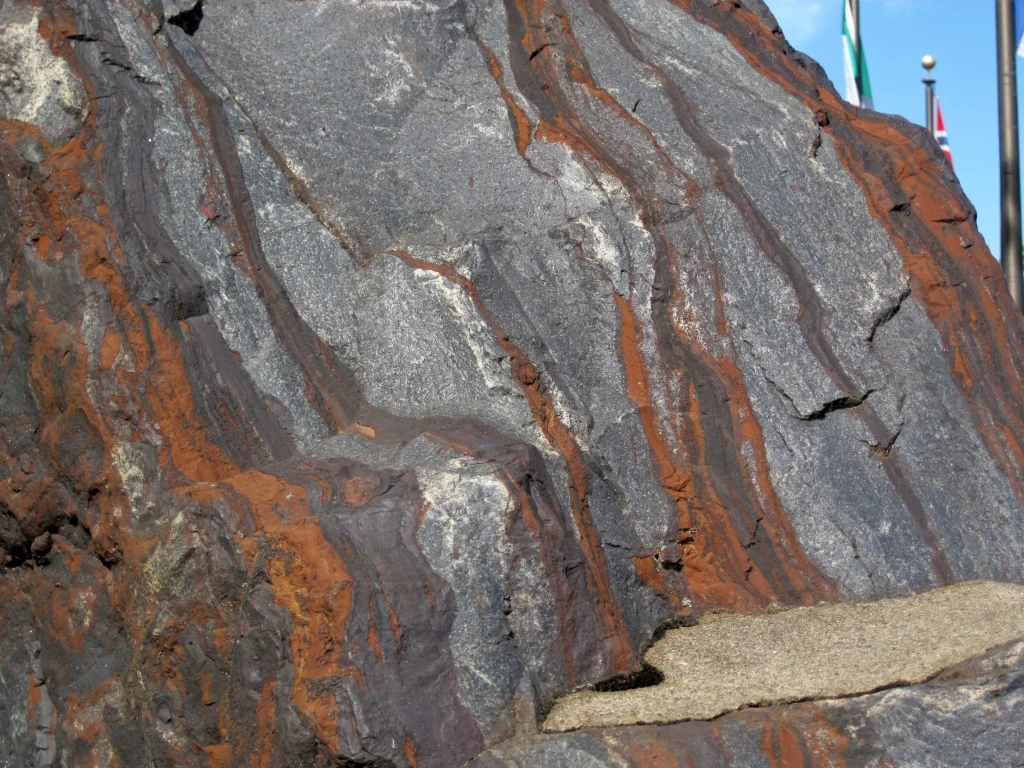 Banded iron formation with alternating red and grey layers, formed during the rise of atmospheric oxygen
