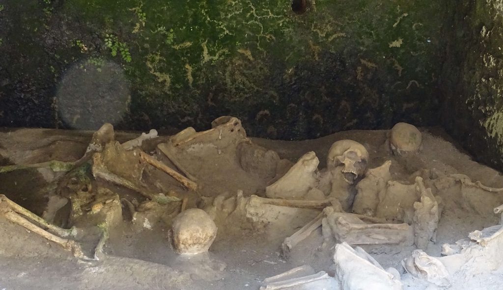 Skeletons of Vesuvius victims inside a vaulted boat house on the ancient shoreline of Herculaneum
