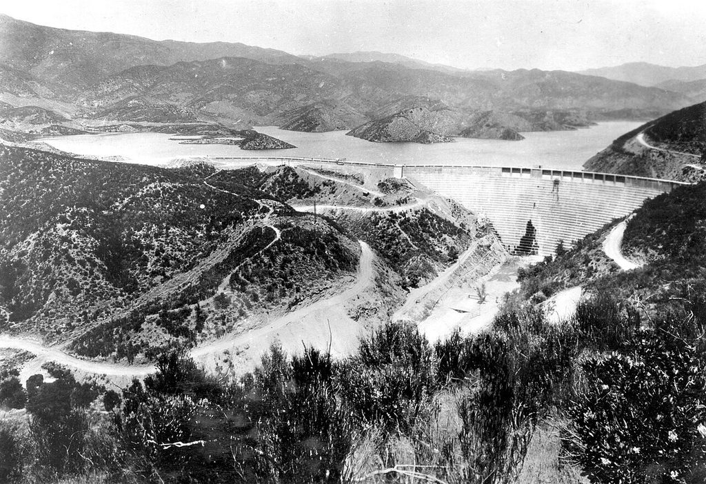 The intact St. Francis Dam with its stepped downstream face and a full reservoir behind it
