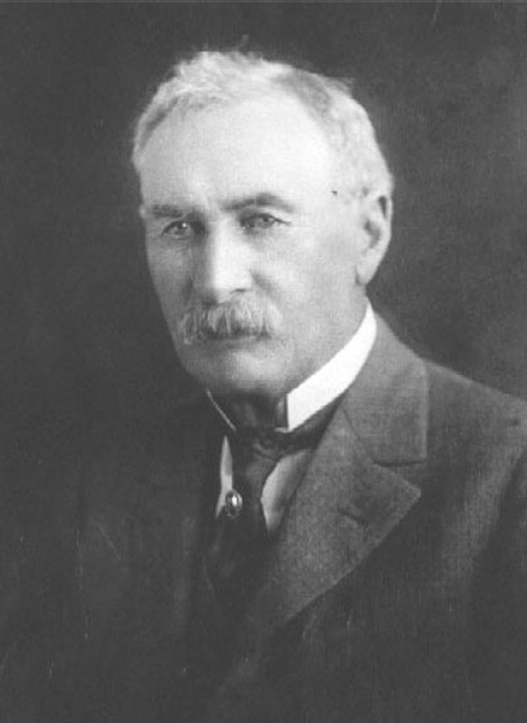 Formal portrait of William Mulholland in a dark suit, 1924