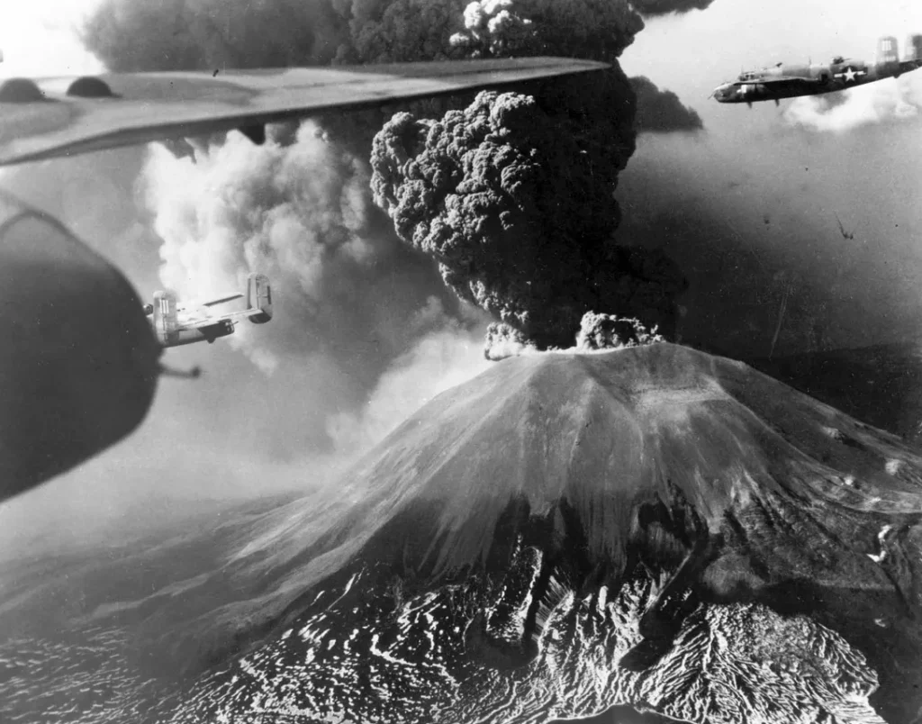A B-25 Mitchell bomber flying past Mount Vesuvius during its March 1944 eruption